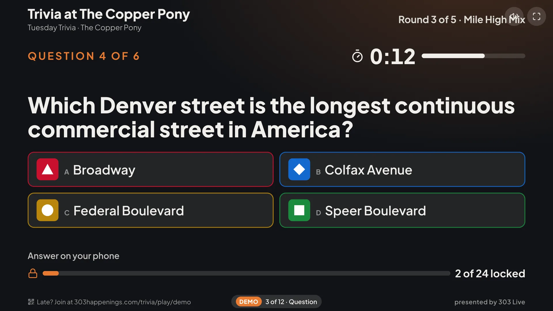 The room screen showing a question with four colored answers, a 12-second timer and how many players have locked in an answer.